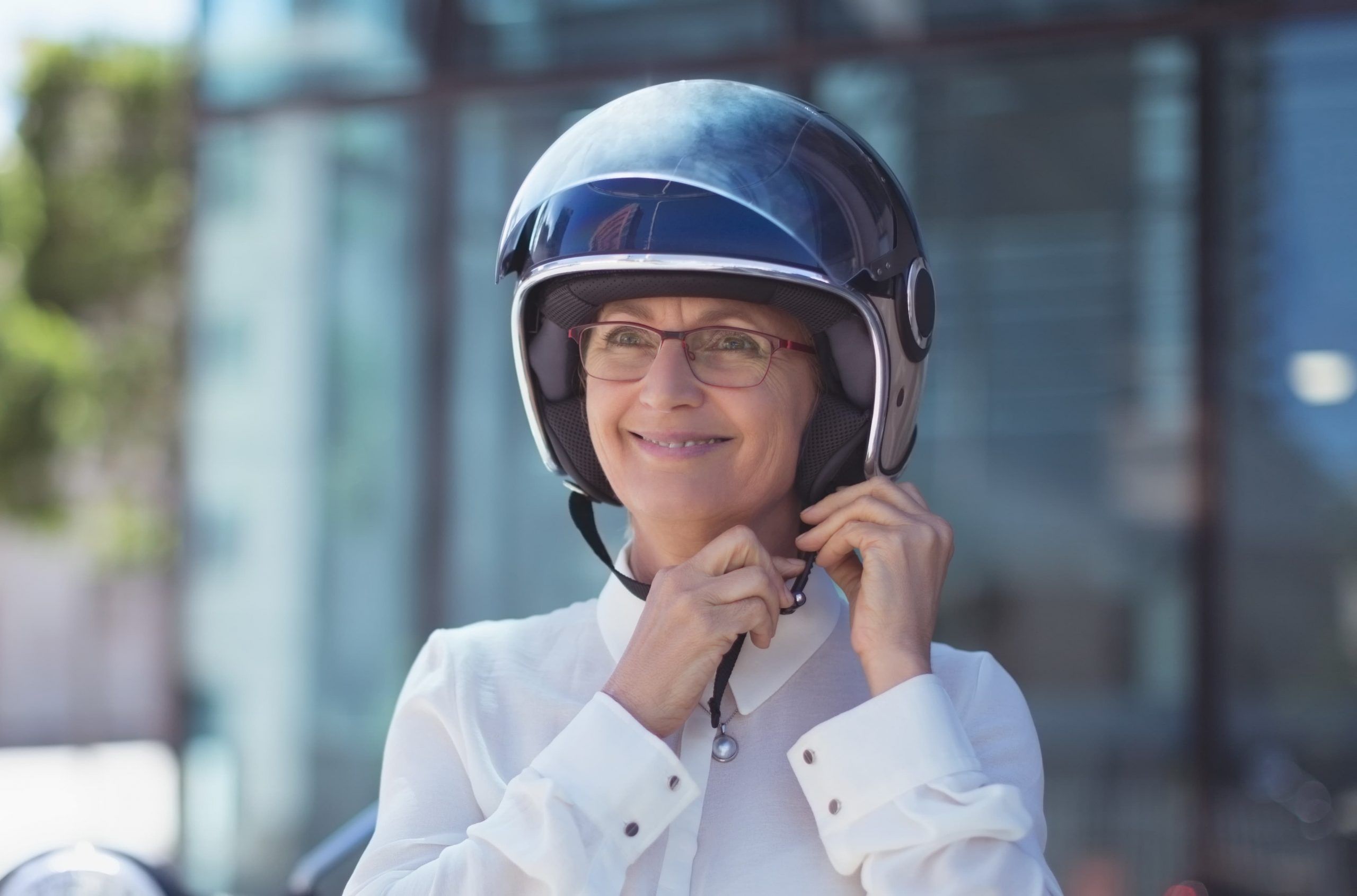 businesswoman-fastening-helmet-XC4MYJR